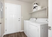 Thumbnail 13 of 26 - a laundry room with a washer and dryer at The Alloy at Geneva, Vineyard, Utah
