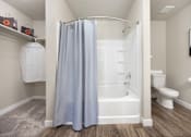 Thumbnail 8 of 26 - a bathroom with a bathtub and a toilet in a 555 waverly unit at The Alloy at Geneva, Vineyard, Utah
