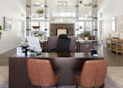 Thumbnail 3 of 26 - a view of the reception desk with a fireplace in the background and a living room in the at The Alloy at Geneva, Vineyard, UT, 84058