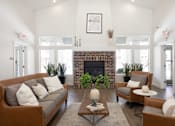 Thumbnail 2 of 26 - a living room with white walls and a brick fireplace at The Alloy at Geneva, Vineyard, UT