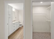 Thumbnail 17 of 98 - A white bathroom with a toilet, sink, and a walk-in closet at The Beaumont Apartments, Bozeman, Montana 59715