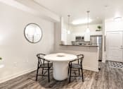 Thumbnail 6 of 35 - a kitchen and dining room with a white table and chairs at Corso Apartments, Missoula, MT