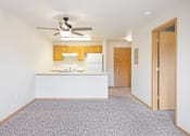 Thumbnail 2 of 31 - a room with a kitchen and a ceiling fan