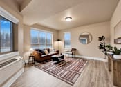 Thumbnail 6 of 27 - A living room with a brown couch and a round mirror on the wall at Brooklyn West Apartments, Montana