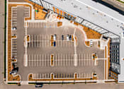 Thumbnail 87 of 98 - An aerial view of a parking lot with cars parked in it at The Beaumont Apartments, Bozeman, MT