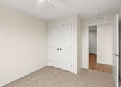 Thumbnail 94 of 98 - A room with a white door and carpeted floor at The Beaumont Apartments, Bozeman, 59715