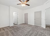 Thumbnail 50 of 61 - A room with a ceiling fan and carpeted floor. at Verraso Village Apartments, Idaho, 83646