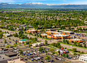 Thumbnail 84 of 98 - A parking lot with cars and a mountain range in the background at The Beaumont Apartments, Bozeman, 59715