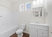 Thumbnail 48 of 61 - A white bathroom with a toilet, sink, and bathtub. at Verraso Village Apartments, Meridian 83646