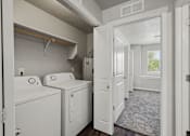 Thumbnail 9 of 28 - a washer and dryer in a laundry room with a window and a door
