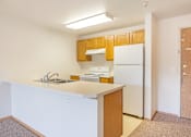 Thumbnail 10 of 31 - a kitchen with a white counter top and a refrigerator