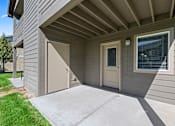 Thumbnail 46 of 56 - A house with a grey siding and a brown door.