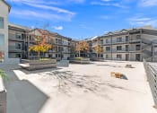 Thumbnail 42 of 48 - a courtyard with benches and buildings at the apartments at River Walk Apartments, Boise, 83702