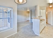 Thumbnail 38 of 60 - a kitchen and living room with a large window at The Vineyards of Colorado Springs, Colorado