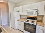 Thumbnail 39 of 60 - a kitchen with white cabinets and stainless steel appliances at The Vineyards of Colorado Springs, Colorado Springs, 80920