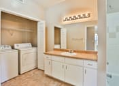 Thumbnail 41 of 60 - a bathroom with a sink and a washer and dryer at The Vineyards of Colorado Springs, Colorado, 80920