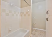 Thumbnail 42 of 60 - a bathroom with white tile and a white bathtub at The Vineyards of Colorado Springs, Colorado Springs, CO