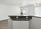 Thumbnail 29 of 43 - A modern kitchen with a black countertop and a wooden floor. at Oakstone Apartments, Clearfield, Utah