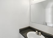 Thumbnail 21 of 43 - A bathroom sink with a mirror above it. at Oakstone Apartments, Clearfield, 84015