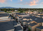 Thumbnail 17 of 61 - A large group of houses with a mountain in the background. at Verraso Village Apartments, Meridian, ID