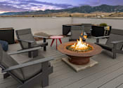 Thumbnail 22 of 23 - A fire pit on a wooden deck with chairs around it at Cannery Flats, Bozeman, Montana