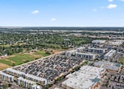 Thumbnail 53 of 61 - A large parking lot is surrounded by buildings and greenery. at Verraso Village Apartments, Idaho, 83646