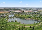 Thumbnail 60 of 61 - A beautiful aerial view of a park with a lake and a fountain. at Verraso Village Apartments, Meridian, ID