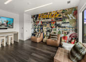 Thumbnail 16 of 23 - A living room with a large wall mural and a flat screen TV at Cannery Flats, Bozeman, Montana