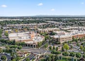 Thumbnail 61 of 61 - A large building complex with a parking lot in front. at Verraso Village Apartments, Meridian, Idaho
