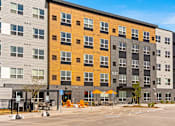 Thumbnail 90 of 98 - A modern apartment building with a parking lot in front at The Beaumont Apartments, Bozeman