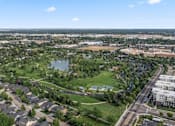 Thumbnail 59 of 61 - A suburban area with a lake and a road with cars. at Verraso Village Apartments, Idaho