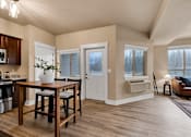 Thumbnail 5 of 27 - A kitchen with a table and chairs in the middle of the room at Brooklyn West Apartments, Missoula