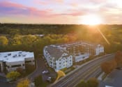 Thumbnail 44 of 48 - an aerial view of a building with the sun setting behind it at River Walk Apartments, Boise, Idaho