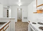 Thumbnail 22 of 26 - A kitchen with white appliances and wooden accents.at Country Oaks Apartments, Clearfield, UT 84015