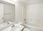 Thumbnail 25 of 26 - A white bathroom with a sink, toilet, and bathtub.at Country Oaks Apartments, Clearfield Utah