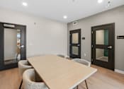 Thumbnail 39 of 98 - A conference room with a long table and chairs at The Beaumont Apartments, Bozeman, 59715