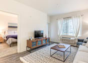 Thumbnail 4 of 35 - a living room with a couch and a coffee table and a tv at Corso Apartments, Missoula, MT