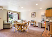 Thumbnail 26 of 31 - a dining area with a table and chairs in a living room