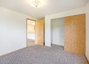 Thumbnail 1 of 31 - an empty room with a door to a closet and a mirror