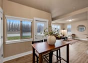 Thumbnail 3 of 27 - A dining room with a wooden table and chairs at Brooklyn West Apartments, Missoula, 59808