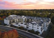 Thumbnail 48 of 48 - an aerial view of a white and gray apartment building with a sunset in the background at River Walk Apartments, Boise, ID