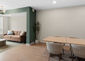 Thumbnail 42 of 98 - Coworking spaces with a couch, chairs, and a table at The Beaumont Apartments, Bozeman, MT