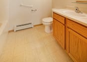 Thumbnail 7 of 31 - a bathroom with a toilet and a sink and a mirror