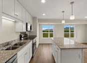 Thumbnail 4 of 98 - A kitchen with granite countertops and white cabinets at The Beaumont Apartments, Bozeman, Montana 59715