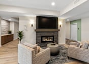 Thumbnail 51 of 98 - Modern resident lounge space with a fireplace and a flat screen TV mounted above it at The Beaumont Apartments, Bozeman, 59715
