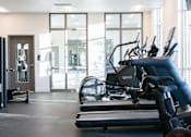 Thumbnail 19 of 52 - A gym with treadmills and exercise equipment.at Copestone Apartments, Garden City, ID 59808