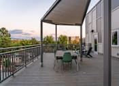 Thumbnail 44 of 52 - A wooden deck with a table and chairs.at Copestone Apartments, Idaho, 59808