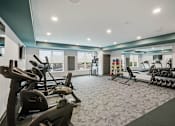 Thumbnail 14 of 51 - A spacious gym with a variety of exercise equipment.