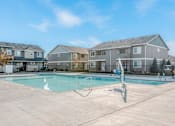 Thumbnail 23 of 28 - a swimming pool with apartment buildings in the background