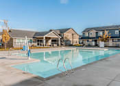 Thumbnail 21 of 28 - a swimming pool with apartments in the background